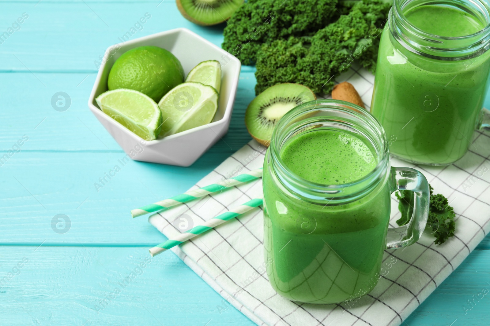 Photo of Tasty fresh kale smoothie on light blue wooden table