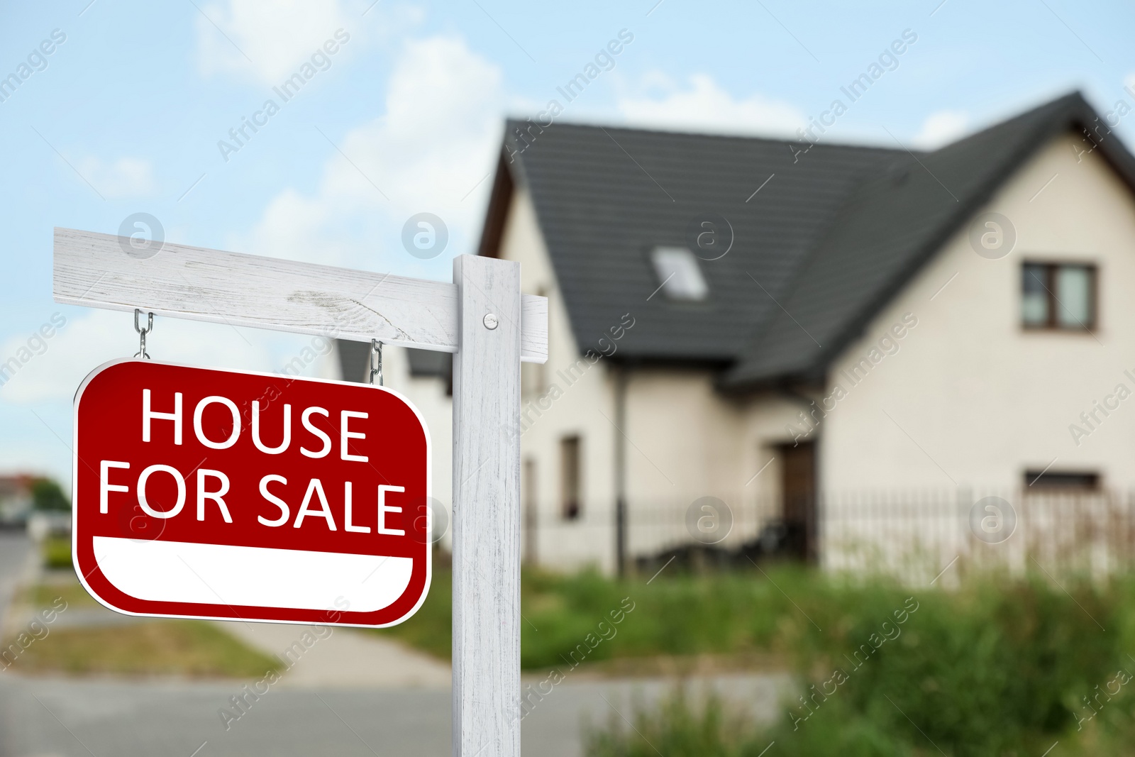 Image of Sale sign near beautiful house outdoors. Red signboard with words