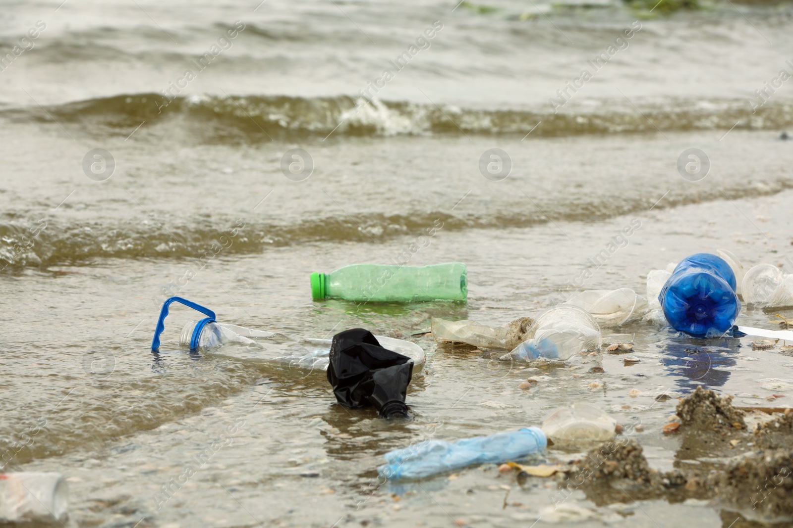 Photo of Beach polluted with plastic garbage. Ecological problem