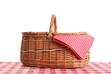 Photo of Empty picnic basket on checkered tablecloth against white background
