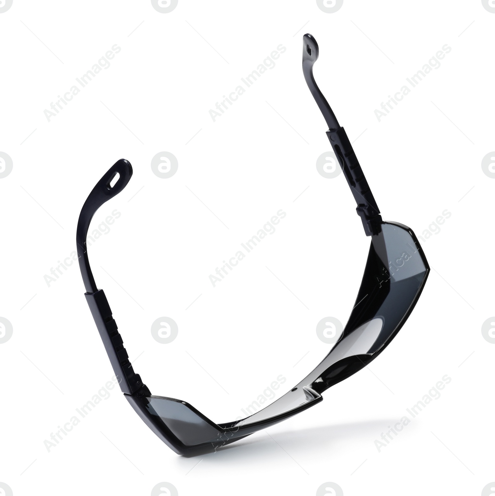 Photo of Protective goggles on white background. Construction tool