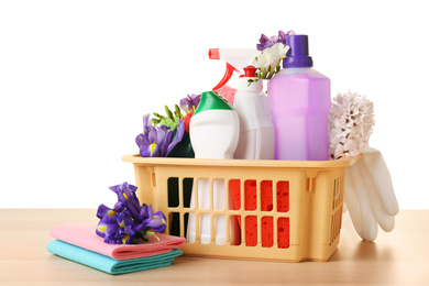 Photo of Spring flowers and cleaning supplies on wooden table