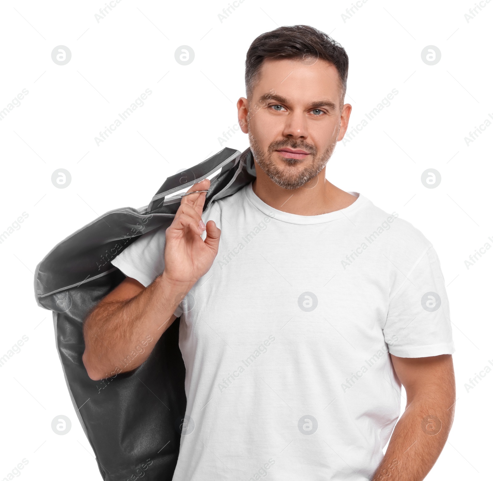 Photo of Man holding garment cover with clothes on white background. Dry-cleaning service