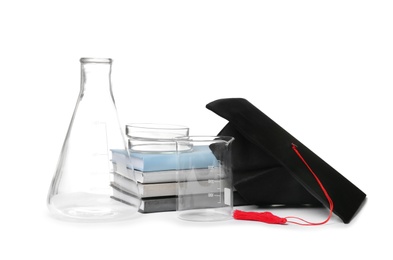 Photo of Medical students stuff, books and graduation hat isolated on white