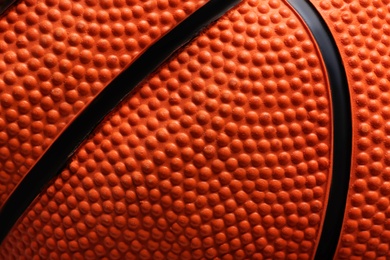 Photo of Texture of orange basketball ball as background, closeup view