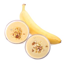 Photo of Tasty banana smoothie with almond and fresh fruit on white background, top view
