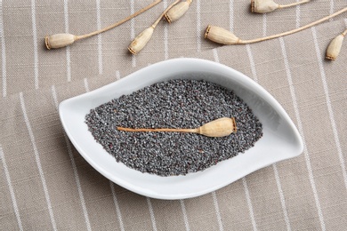 Photo of Flat lay composition with poppy seeds on striped cloth