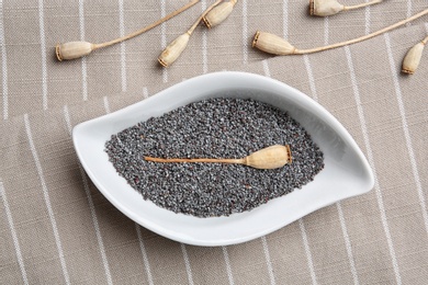 Flat lay composition with poppy seeds on striped cloth