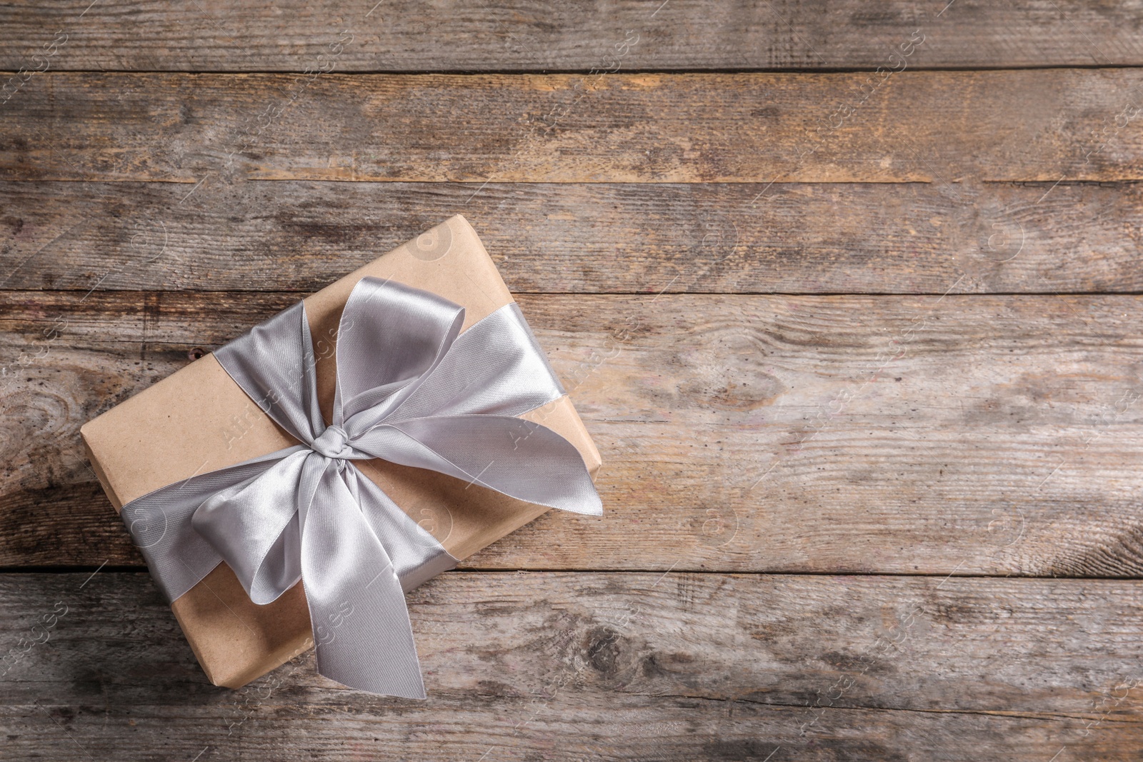 Photo of Beautiful gift box on wooden background, top view