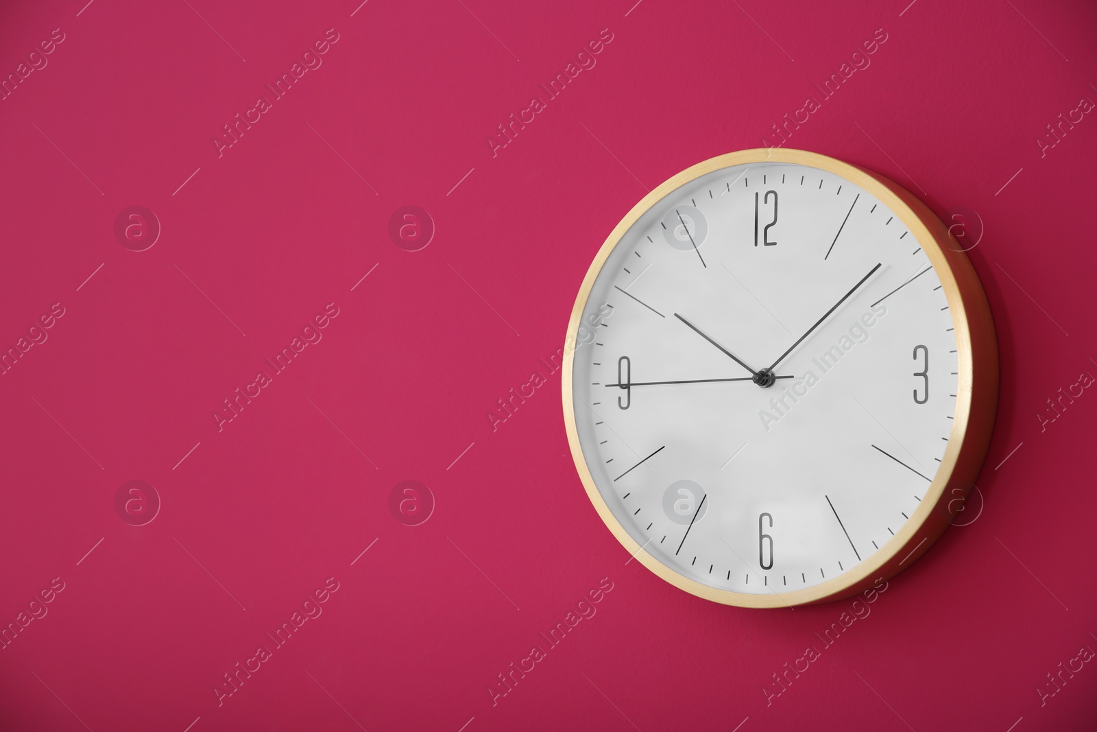 Photo of Stylish clock on color wall. Time concept