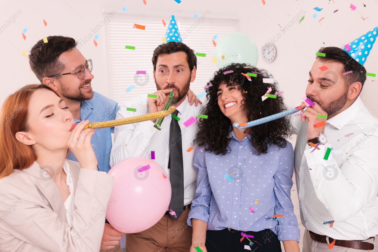 Photo of Coworkers having fun during office party indoors