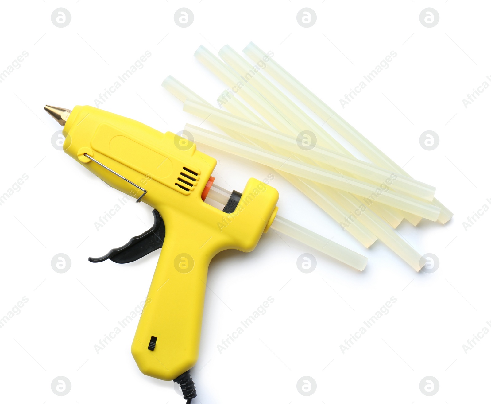 Photo of Yellow glue gun and sticks on white background, top view