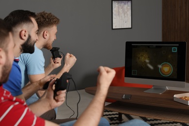 Group of friends playing video games at home