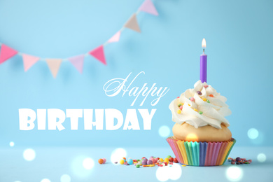 Delicious cupcake with candle on light blue background. Happy Birthday