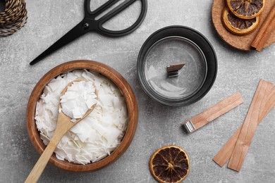 Flat lay composition with ingredients for homemade candles on grey background