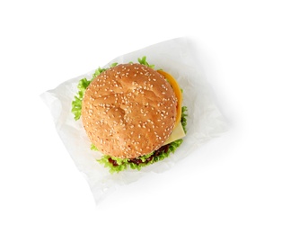 Parchment with tasty fresh burger isolated on white, top view