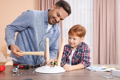 Father and son making stool at home. Repair work