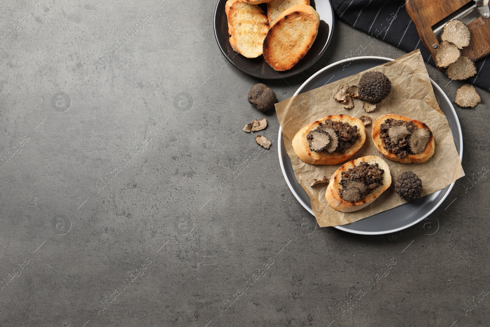 Photo of Delicious bruschettas with truffle sauce on grey table, flat lay. Space for text