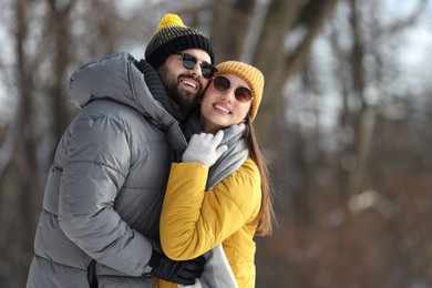 Photo of Beautiful happy couple outdoors on winter day. Space for text