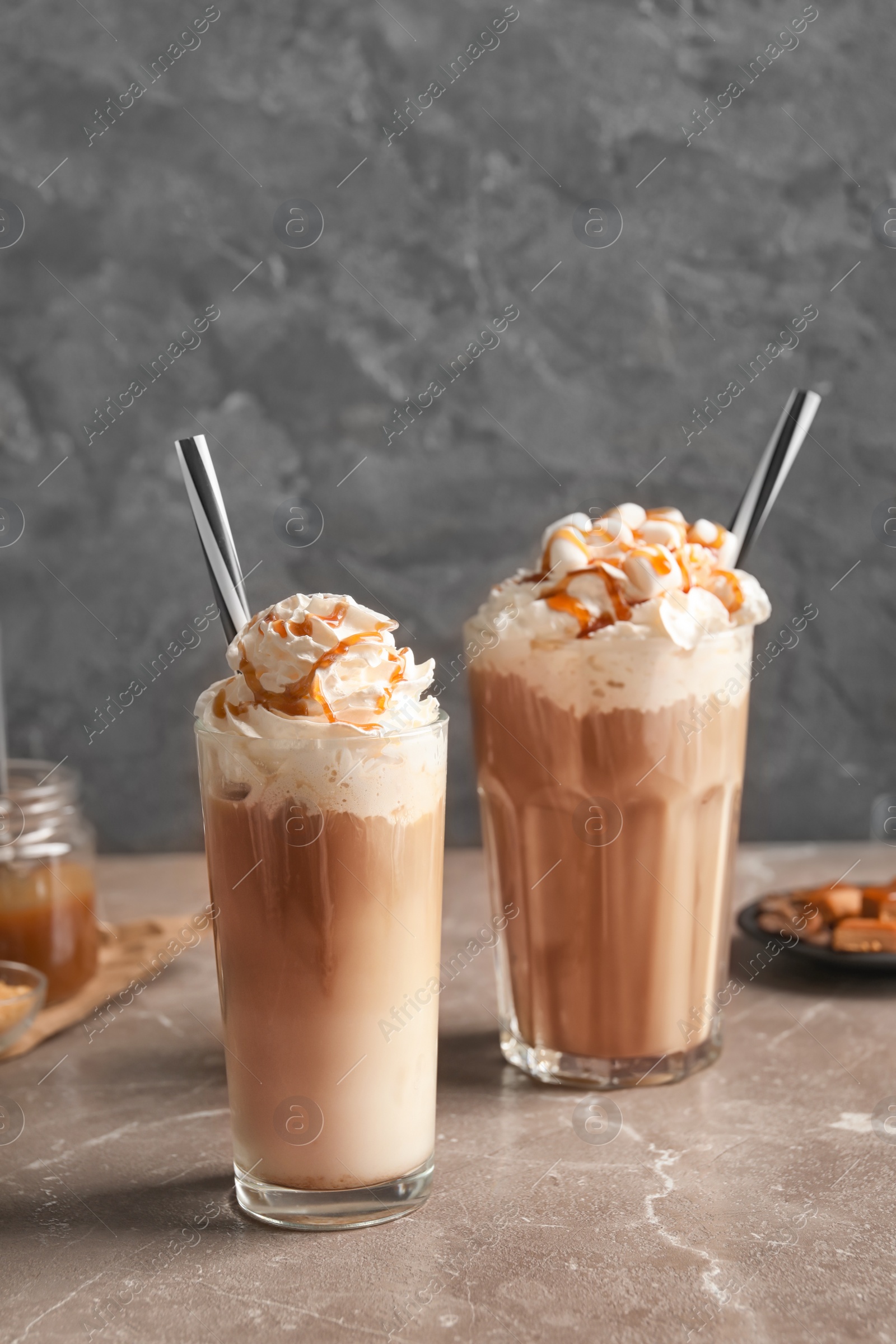 Photo of Glasses with delicious caramel frappe on table