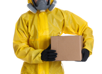 Photo of Man wearing chemical protective suit with cardboard box on white background, closeup. Prevention of virus spread