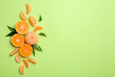 Photo of Composition with tangerines and leaves on color background, flat lay. Space for text