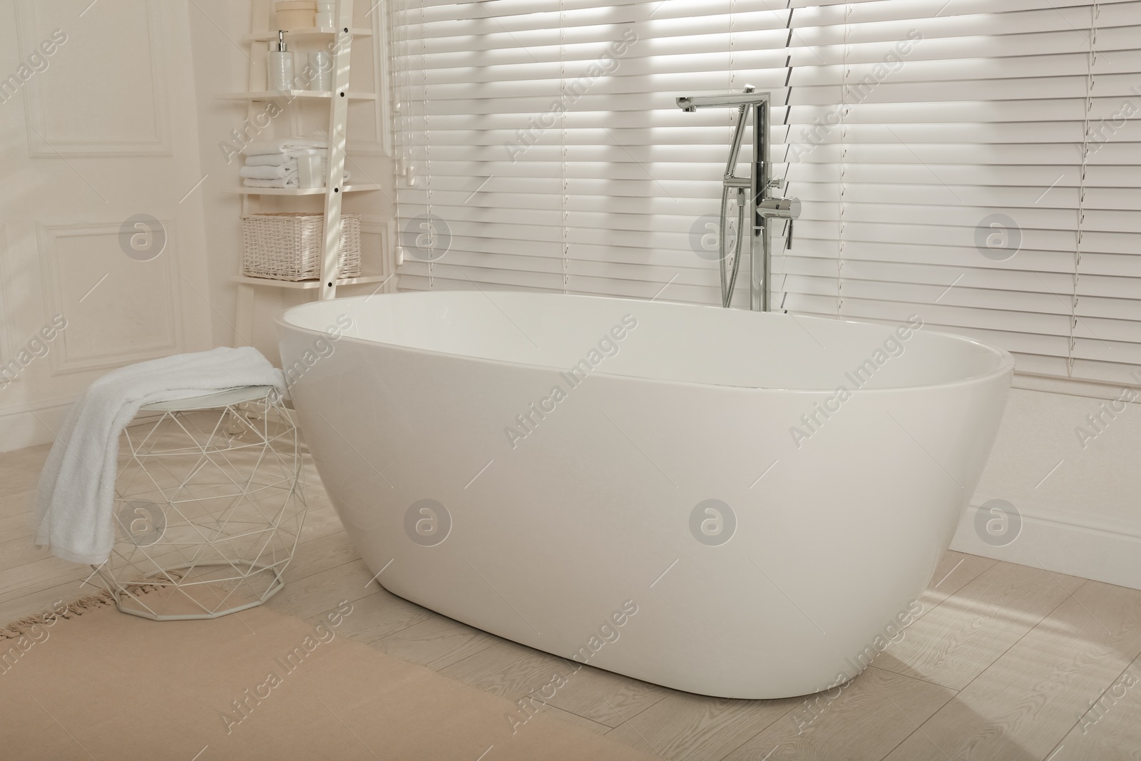 Photo of Minimal bathroom interior with modern white tub