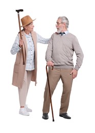 Photo of Senior man and woman with walking canes on white background