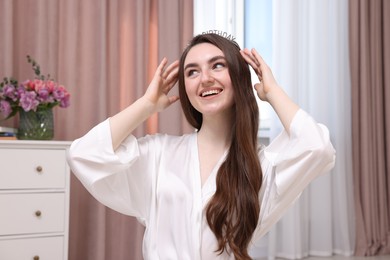 Photo of Beautiful young woman in headband in room. Happy Birthday