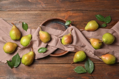 Flat lay composition with ripe pears on wooden background