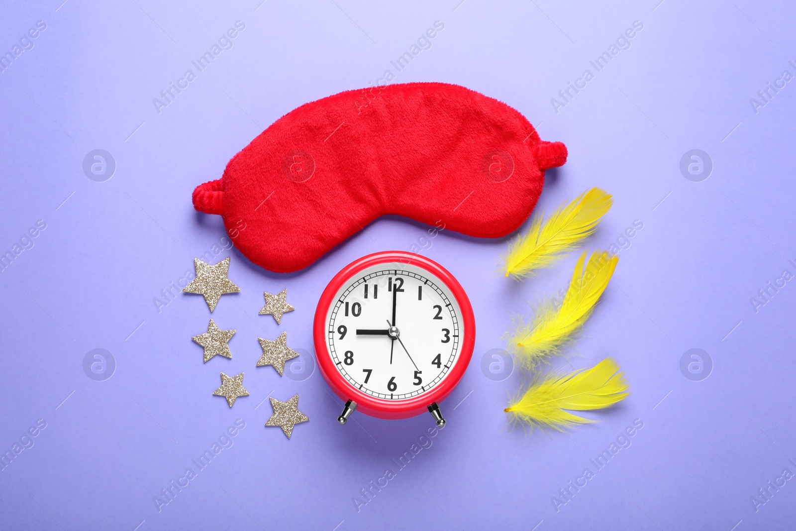 Photo of Soft sleep mask, confetti in shape of stars, feathers and alarm clock on purple background, flat lay