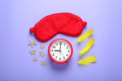 Photo of Soft sleep mask, confetti in shape of stars, feathers and alarm clock on purple background, flat lay