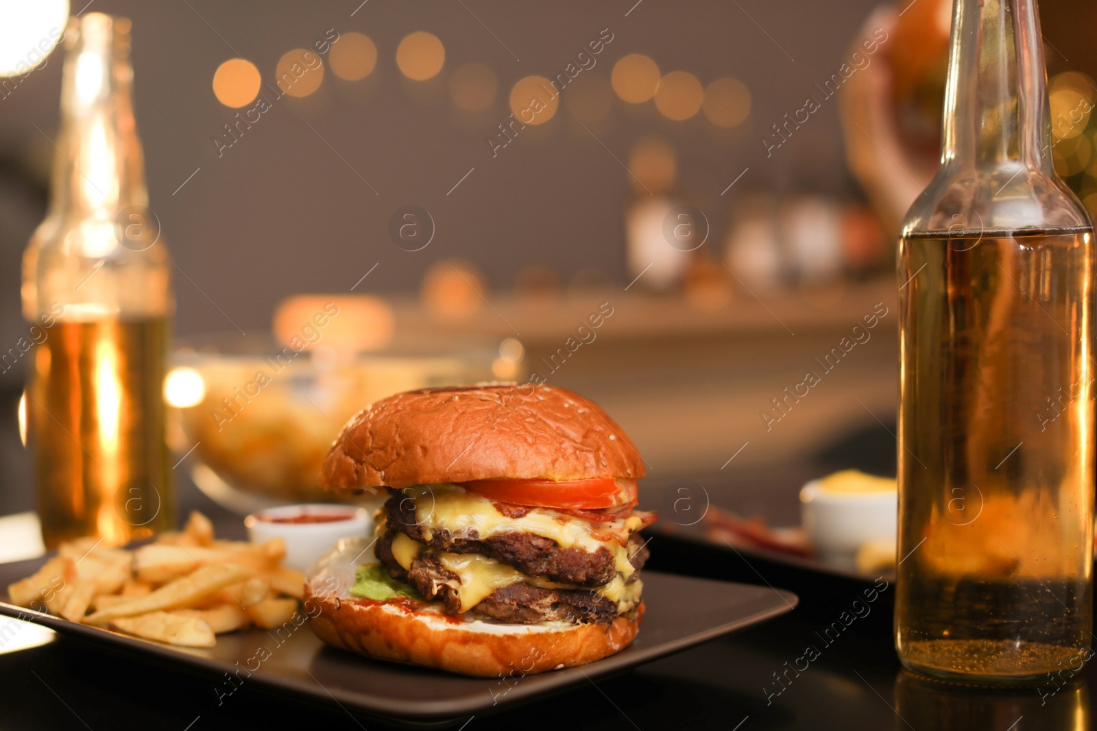 Photo of Tasty burger and french fries served on table in cafe