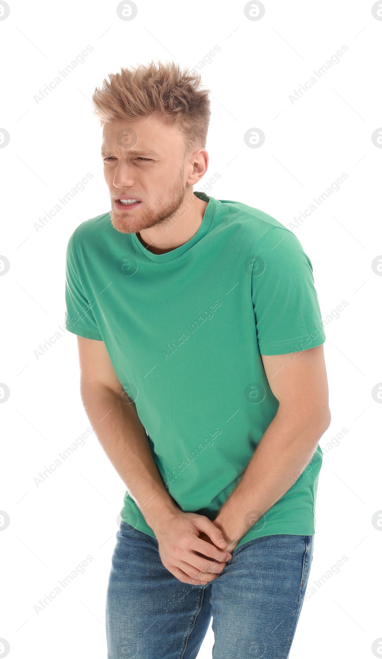 Photo of Young man suffering from pain on white background. Urology problems