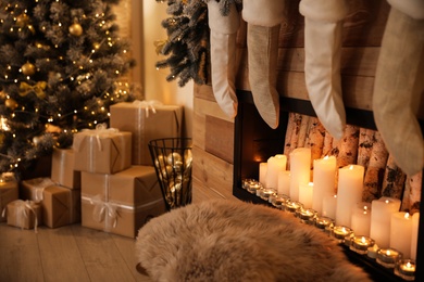 Photo of Stylish room interior with decorative fireplace. Christmas time