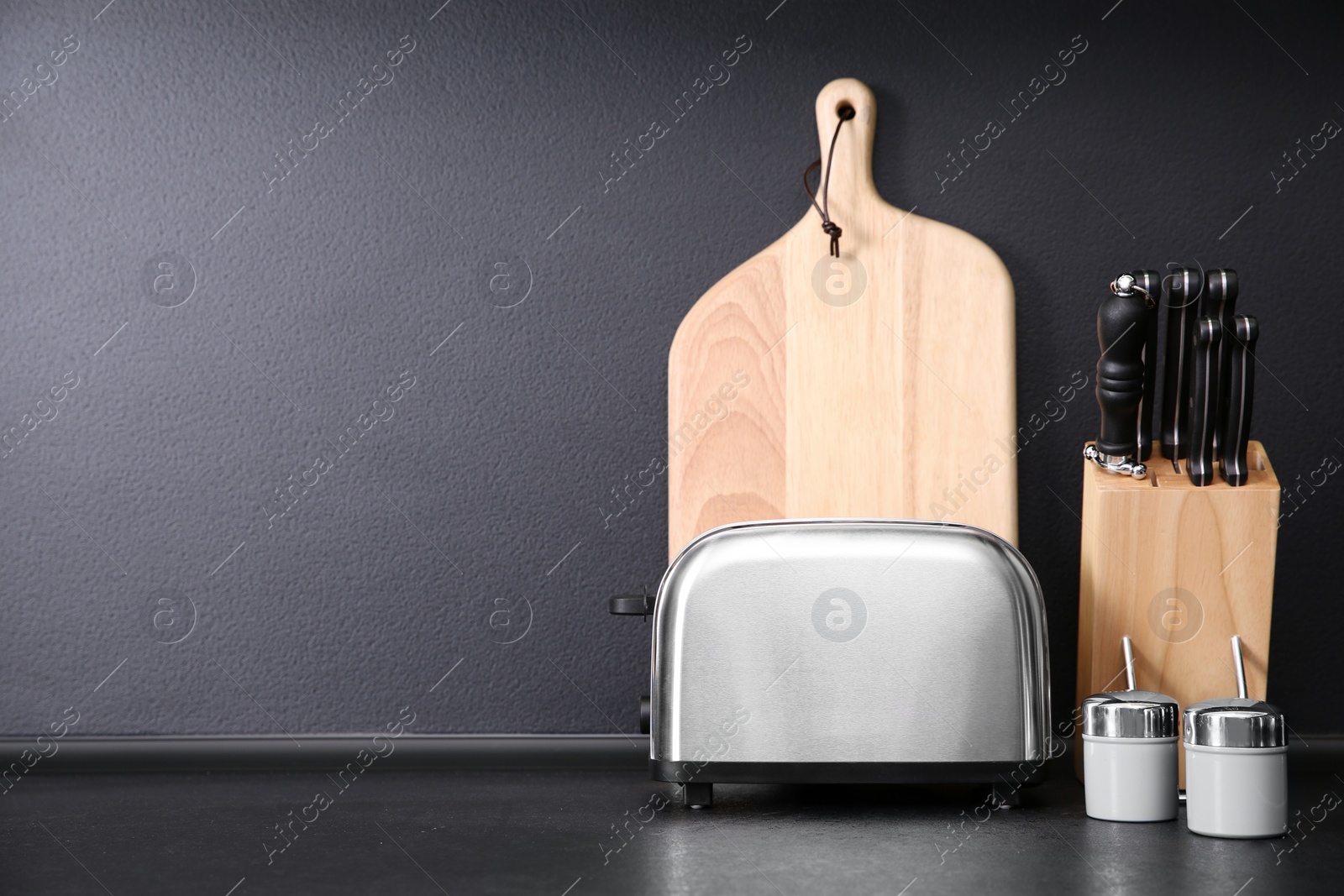 Photo of Composition with kitchenware on table against grey background. Space for text