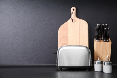 Composition with kitchenware on table against grey background. Space for text