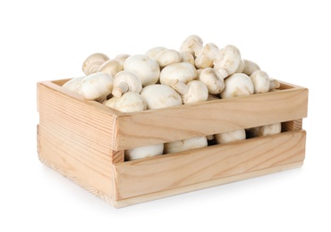 Photo of Wooden crate full of fresh raw mushrooms on white background