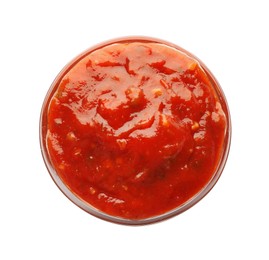 Photo of Delicious adjika sauce in bowl isolated on white, top view