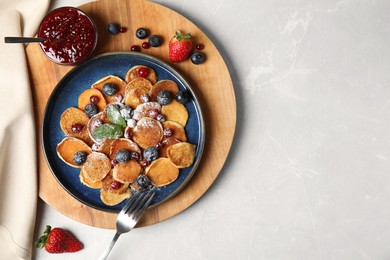 Photo of Cereal pancakes with berries on light grey marble table, flat lay. Space for text