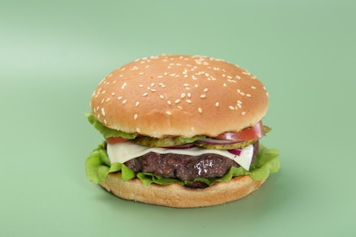 Photo of Burger with delicious patty on green background