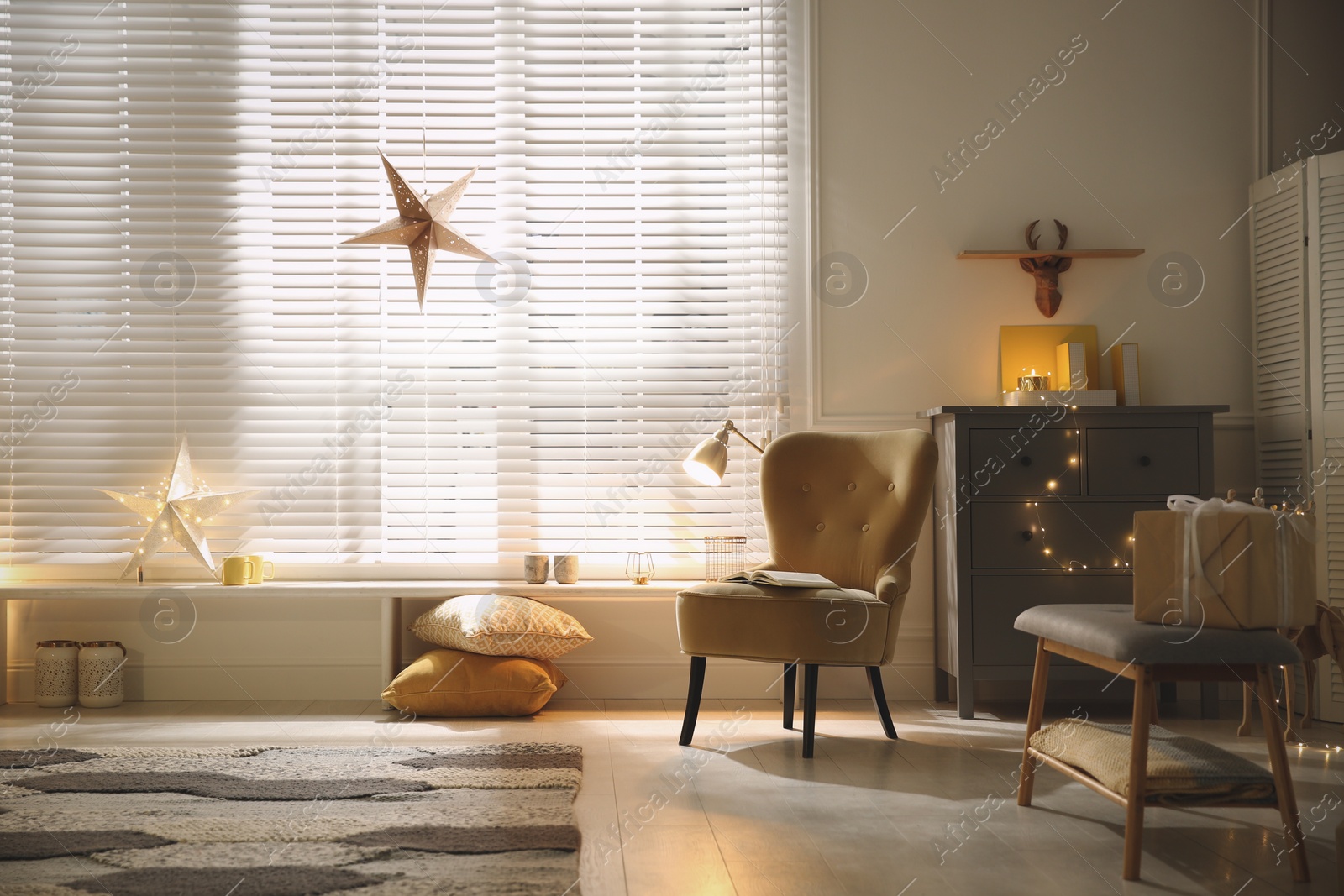 Photo of Bright room decorated with festive lights and stars