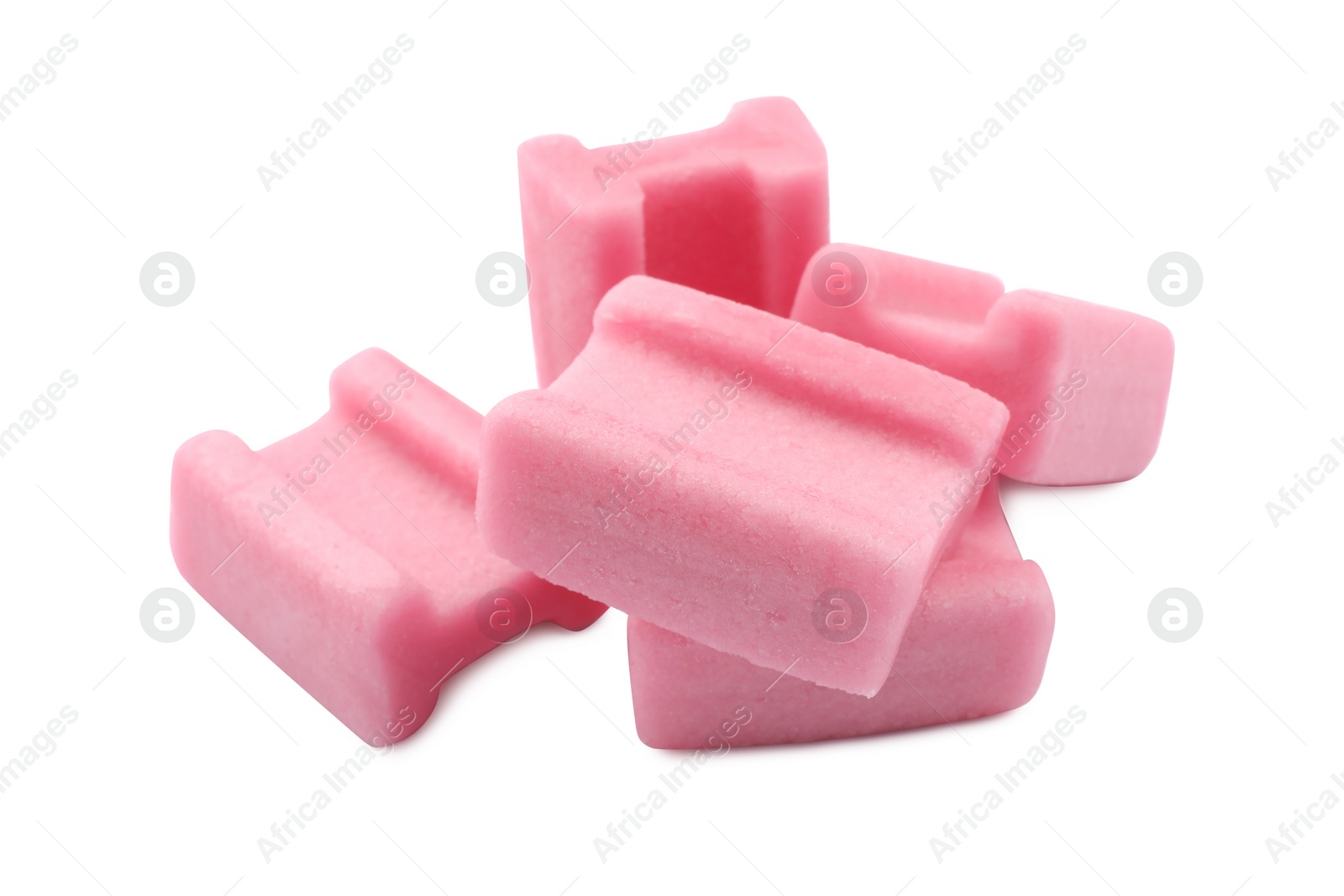 Photo of Many tasty pink chewing gums on white background