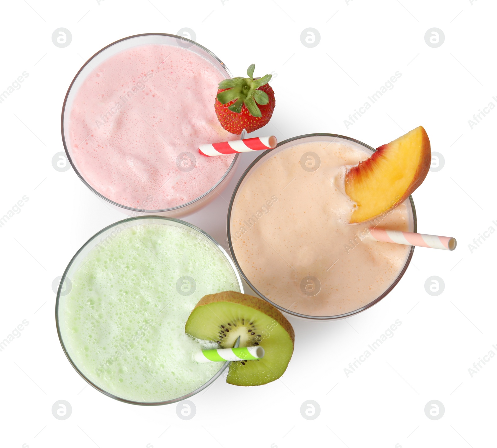 Photo of Glasses of tasty milk shakes on white background, top view