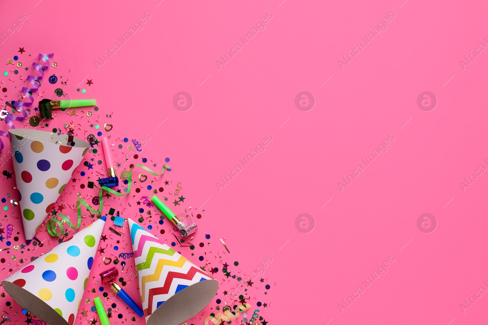 Photo of Beautiful flat lay composition with festive items on pink background, space for text. Surprise party concept