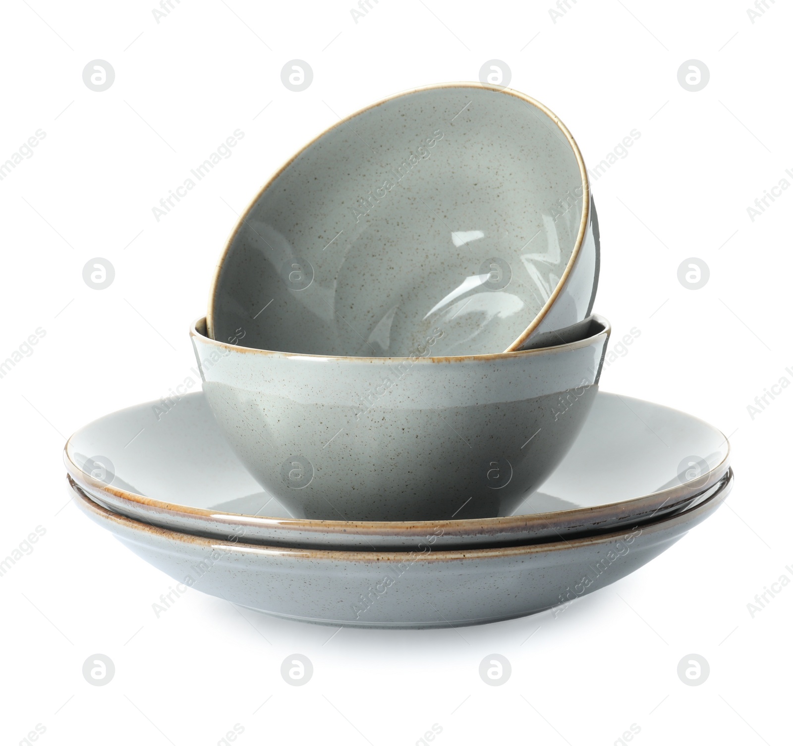 Photo of New grey ceramic plates and bowls on white background