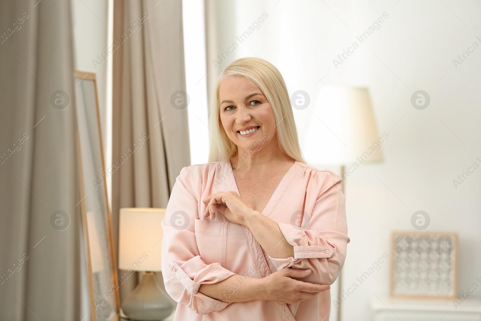 Photo of Portrait of happy mature woman at home