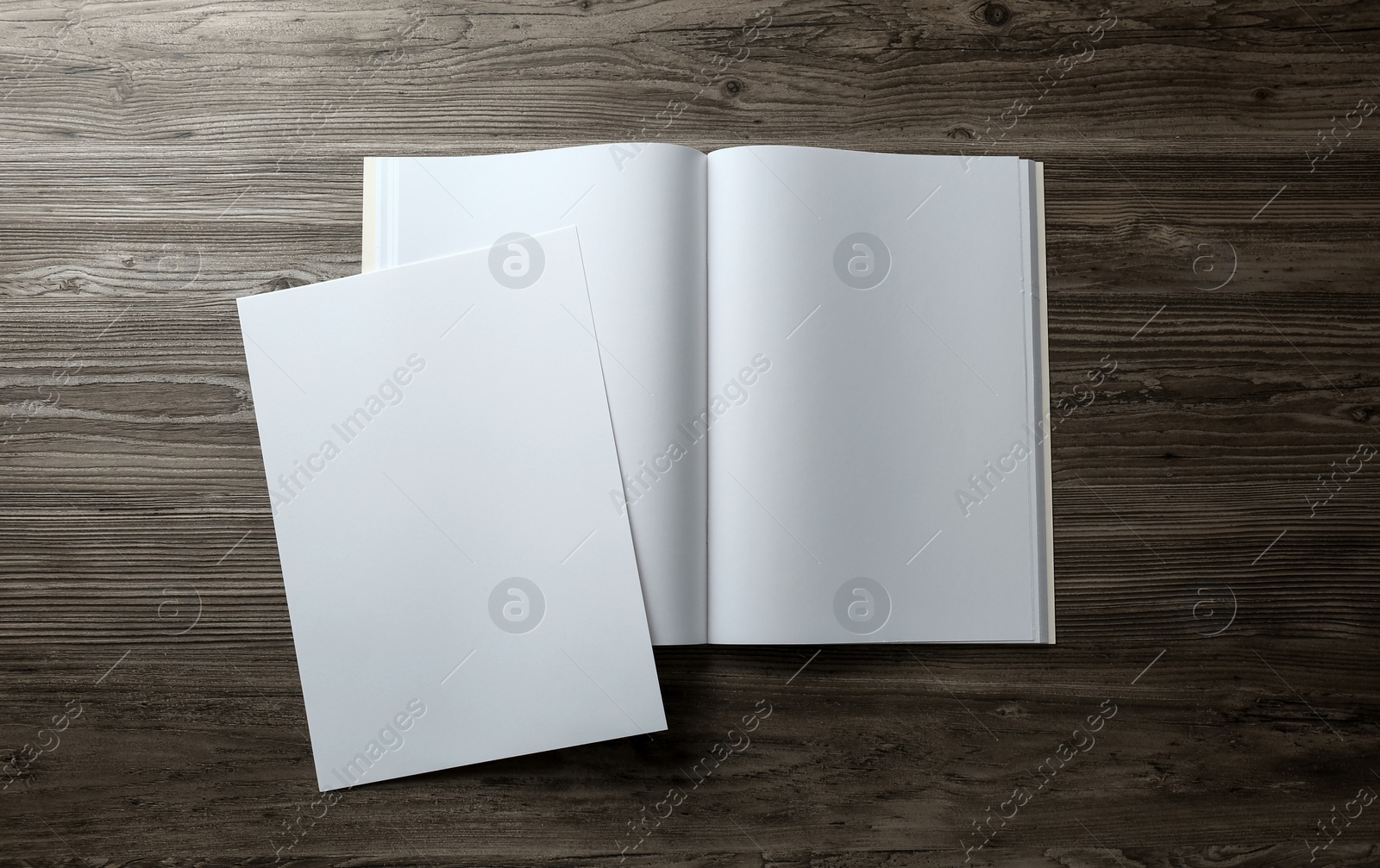 Photo of Sheet of paper and blank brochure on wooden table, flat lay. Mockup for design