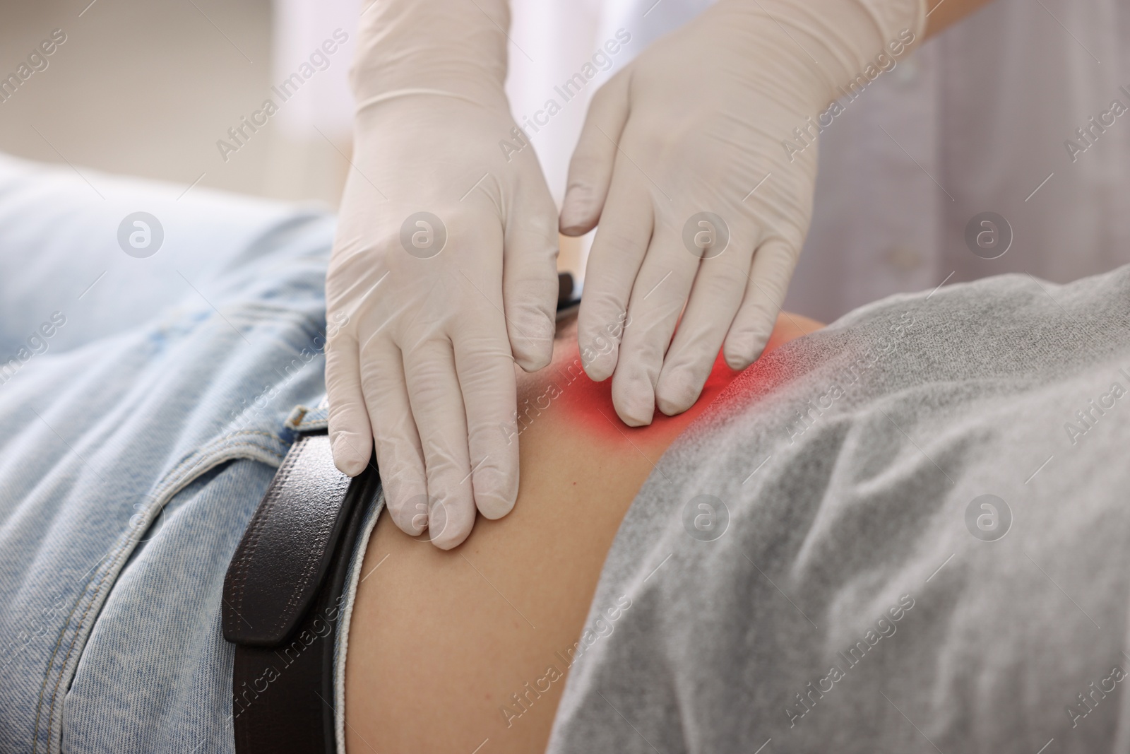 Image of Gastroenterologist examining patient with stomach pain in clinic, closeup