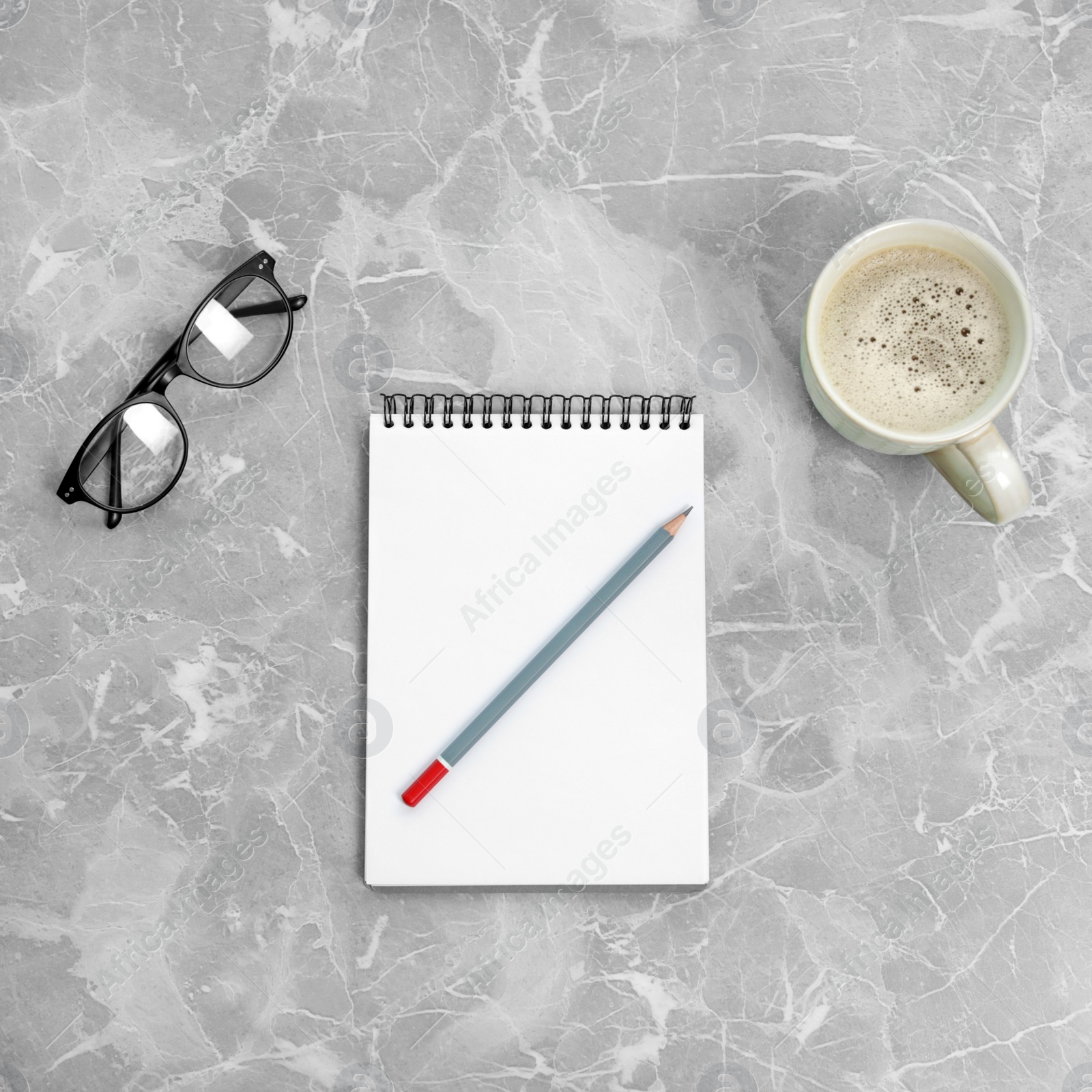 Photo of Flat lay composition with office stationery and cup of coffee on marble table